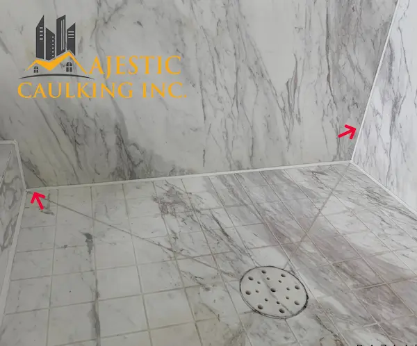 Worker caulking a window